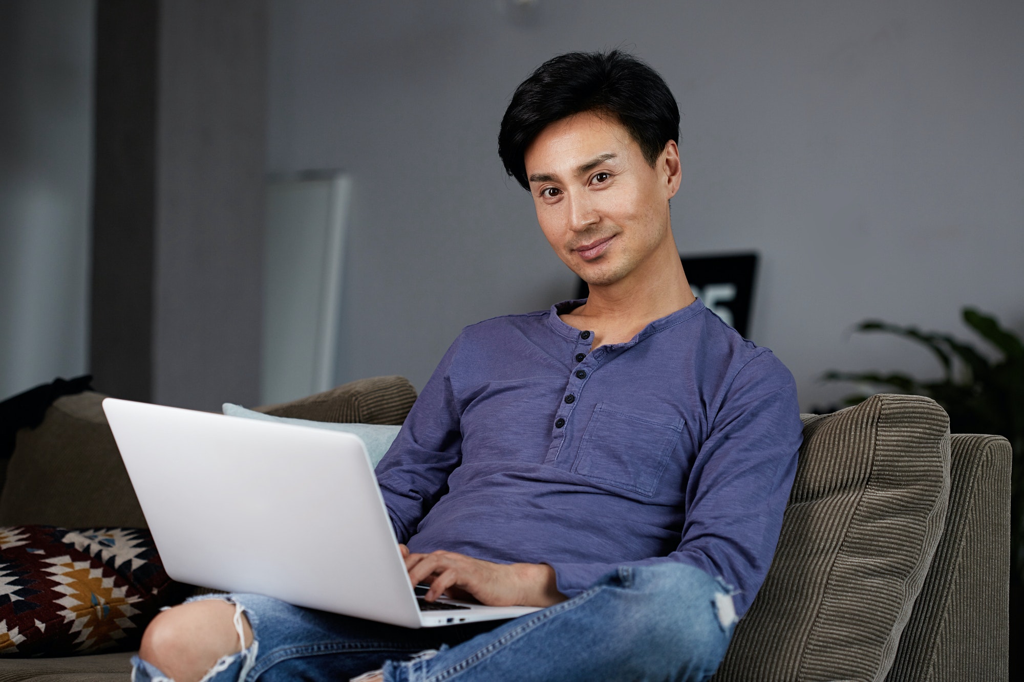 Asian Man Working Laptop Home Connecting Networking Concept